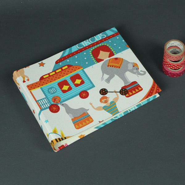 Helles kleines Kinderfotoalbum mit türkis bunten Zirkusmotiven