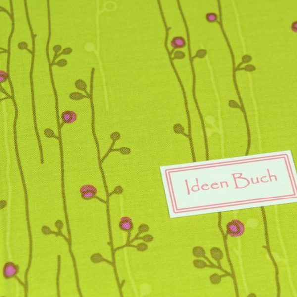 Zart grün pink gemustertes Notizbuch mit bunten linierten Registerseiten